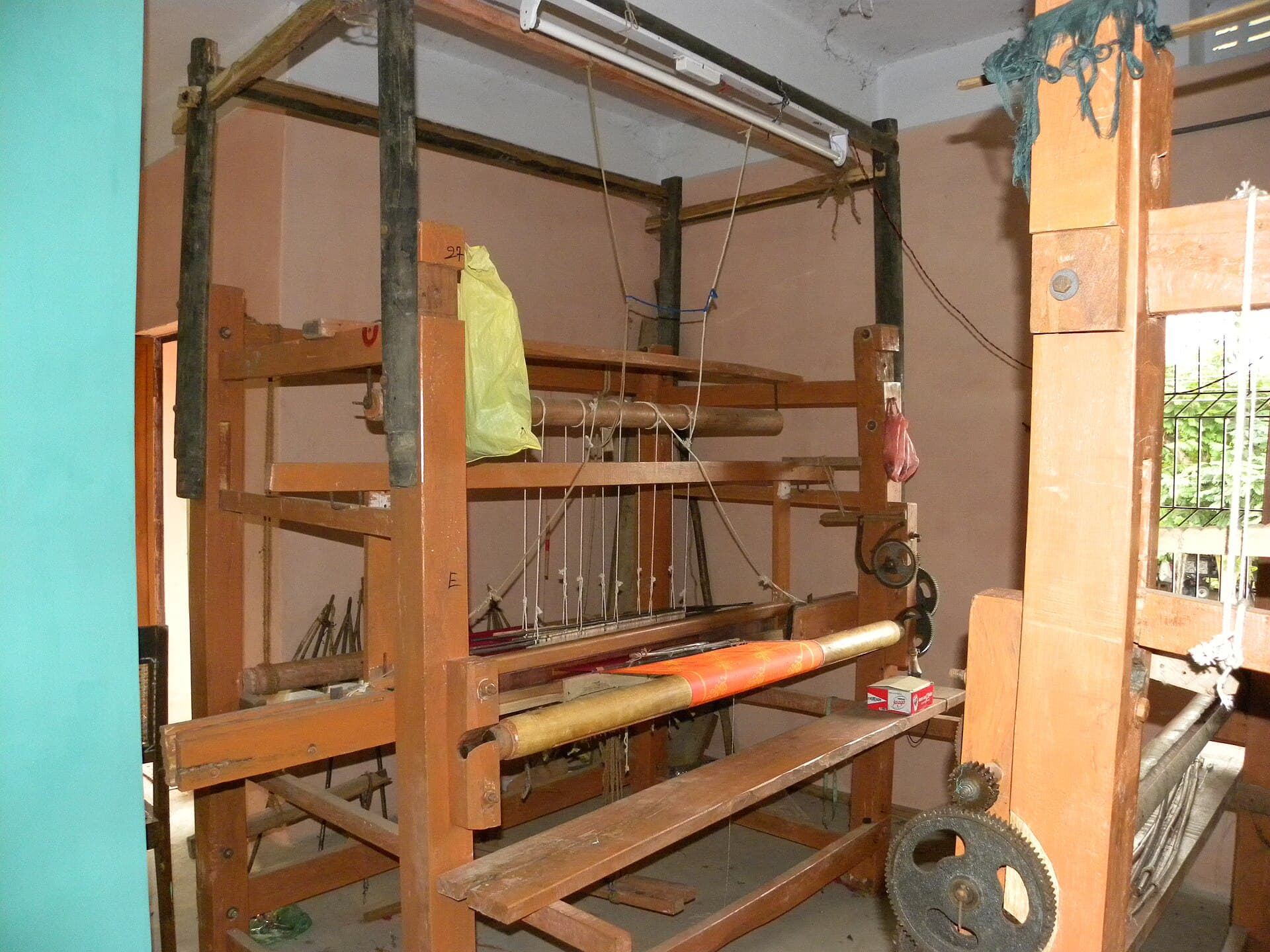 A traditional wooden handloom, warped and dressed for a new run of dohar.